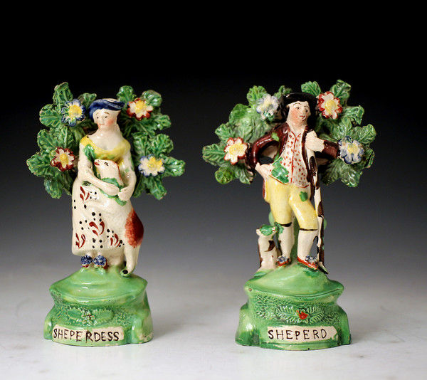 Staffordshire pottery figures of a shepherd and shepherdess with bocage c1820