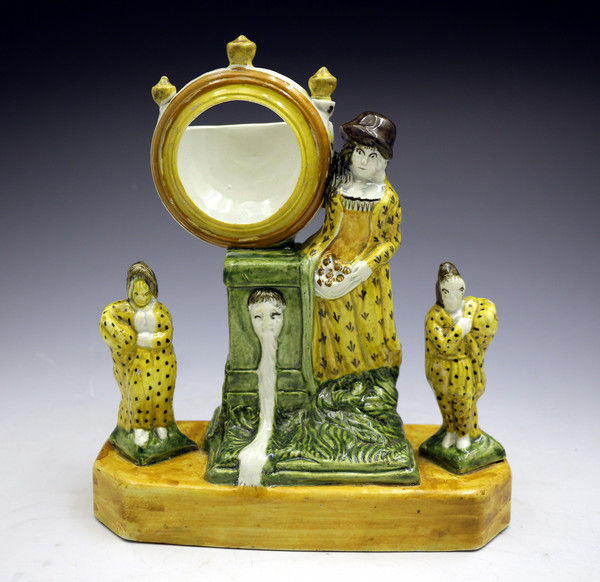 Antique English pottery watch holder flanked by two figures, Prattware c1800