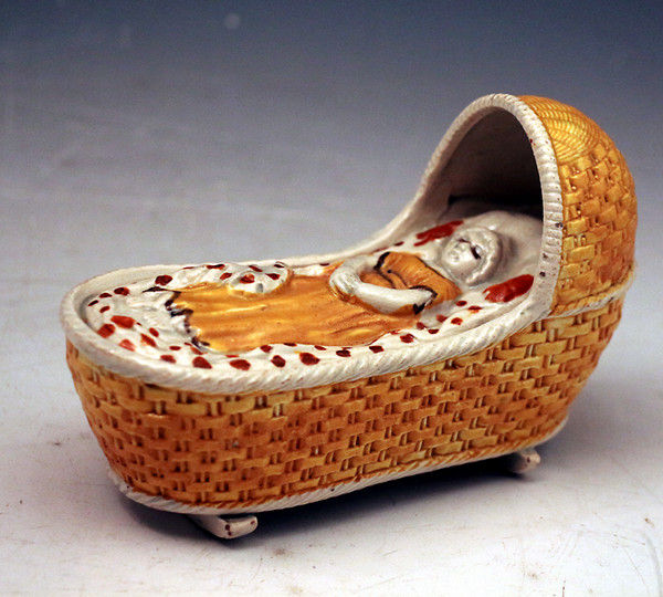Antique pottery baby in cradle in prattware  Staffordshire / Yorkshire c1810
