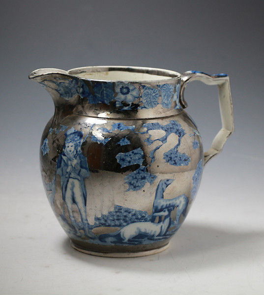 Antique English pottery silver luster pitcher with blue and white transfer.