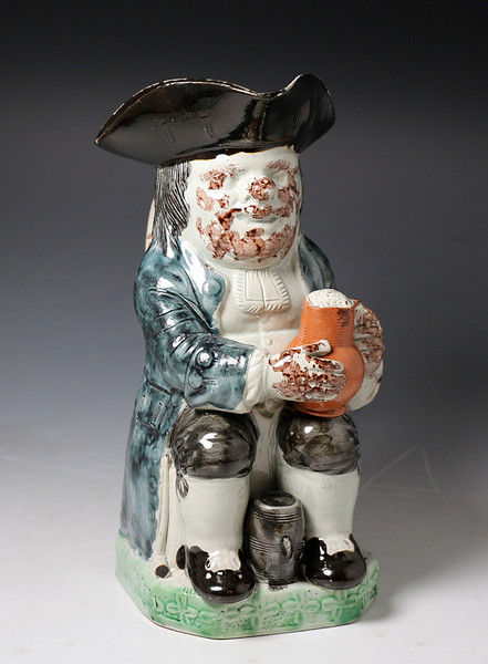 Antique Staffordshire pottery figure of a Toby Jug in colored glazes