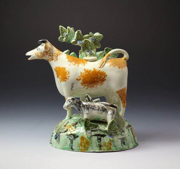 Antique pottery figure cow creamer with bocage and calf late 18th century