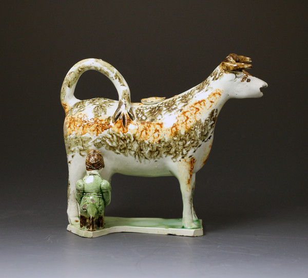 English pottery  cow creamer with the figure of  a milk maid antique period circa 1800.