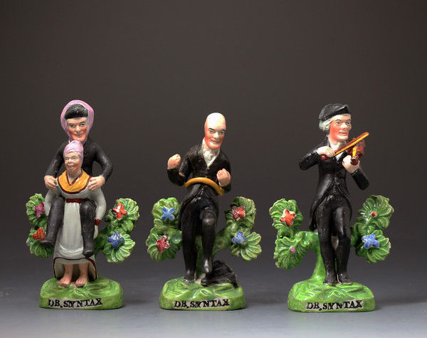  English Staffordshire pottery pearlware bocage figures of  Doctor Syntax the cartoon character.Early 19th century period.      