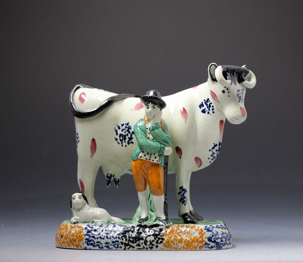 Antique Yorkshire pottery figure of a cow with farm hand in Pratt colours.