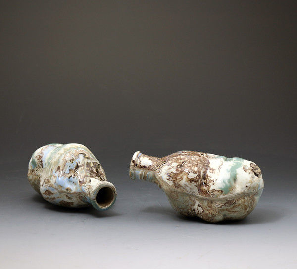 Pair of antique surface decorated agate ware pottery spirit flasks with mocha colors.