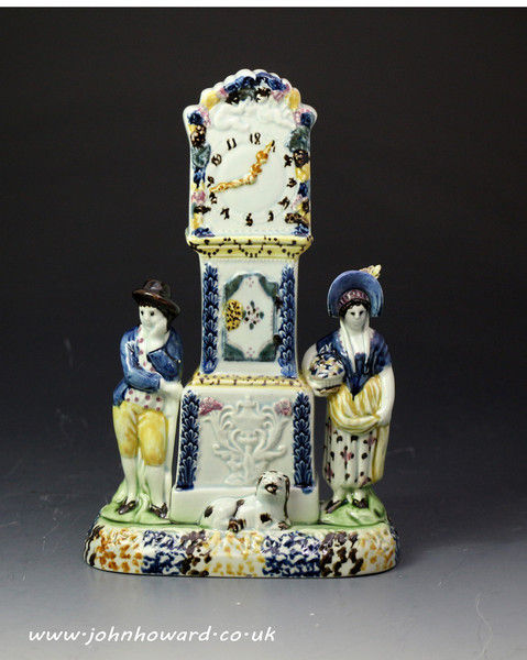 Antique pottery prattware clock group with figures in the form  of a money bank. Yorkshire 1810