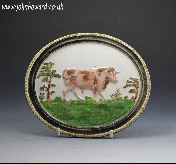 Antique Staffordshire pottery oval plaque with figure of a bull , pearlware galze and enamel colours c1820