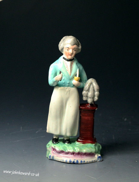 Antique English Staffordshire pearlware pottery figure of a wig maker early 19th century period.