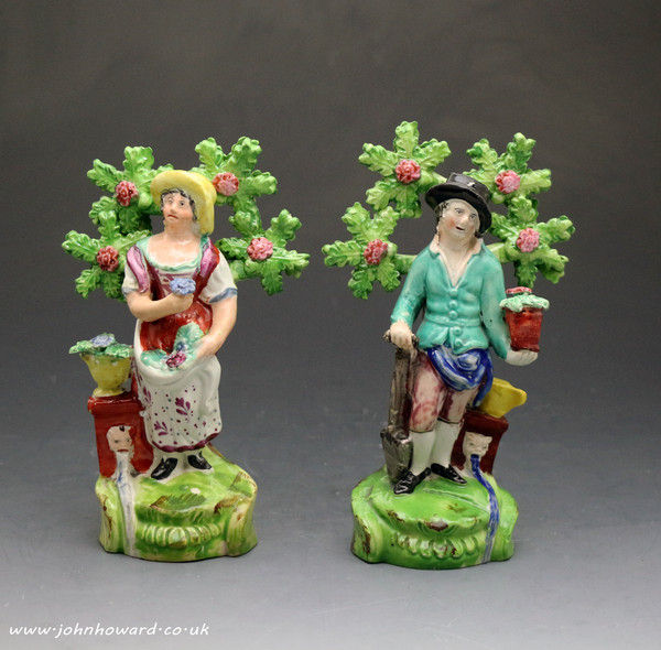 Antique Staffordshire figures of a male and female gardeners early 19th century.