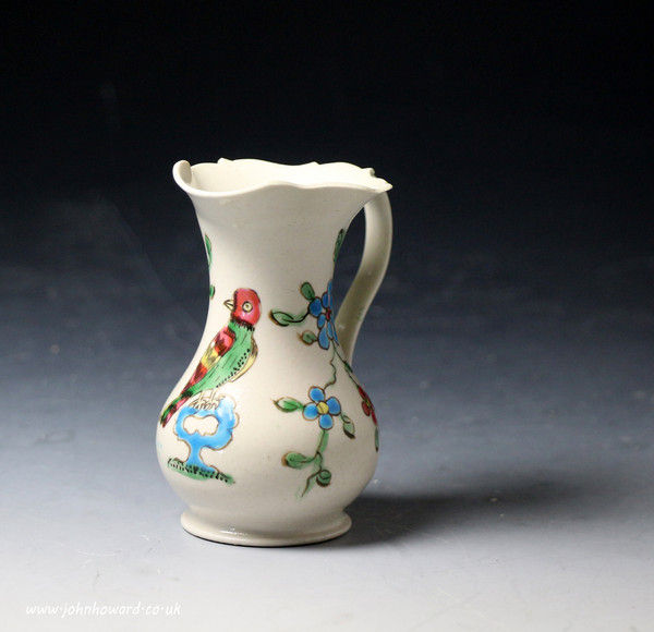 Antique Staffordshire pottery saltglaze cream jug with figure of bird with enamel colours mid18th century