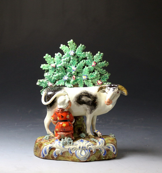 Antique Staffordshire pottery pearlware figure group of cow and milkmaid with bocage early 19th century