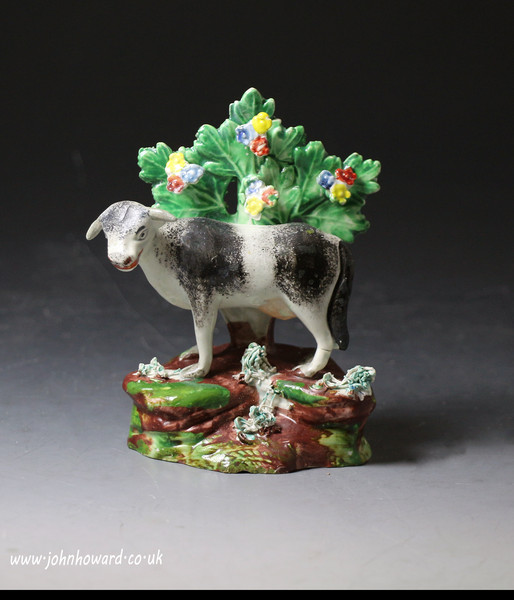 Antique Staffordshire pottery bocage pearlware figure of a cow, early 19th century