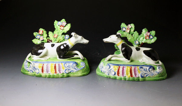 Antique Staffordshire pottery pearlware figures of dogs with bocage in the Sherratt style