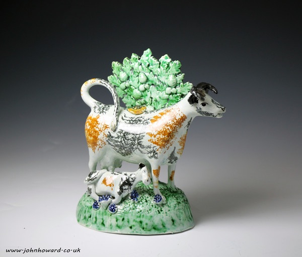 Antique English pottery figure cow creamer with calf and bocage c1790/1800