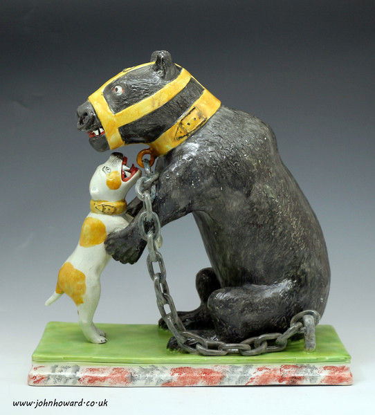 Staffordshire pottery figure of a bear baiting in pearlware early 19th century English.