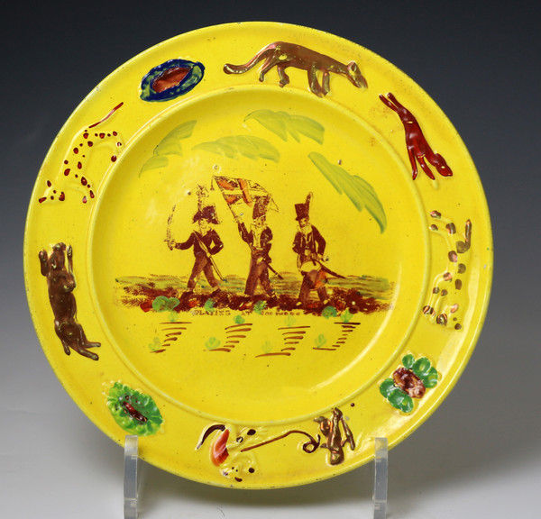 Antique Welsh pottery childs nursery plate in canary yellow showing children 