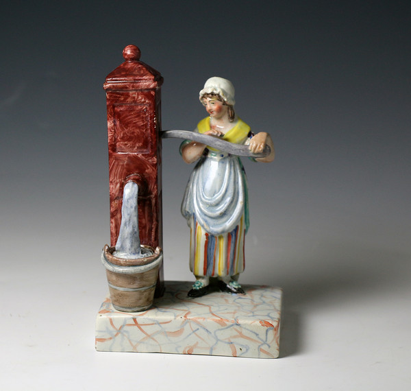 Antique pearlware Staffordshire pottery figure girl at water pump early 19th century