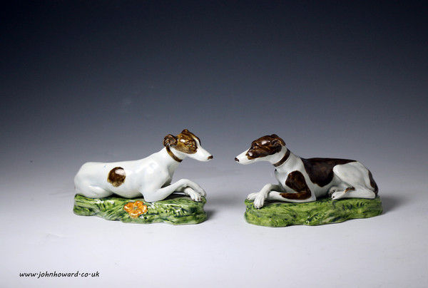 Two Staffordshire pottery pearlware figures of dogs on bases circa 1820 England