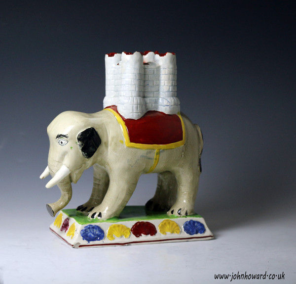 Staffordshire pottery figure of a an elephant carrying a castle form incense burner, Engliah circa 1810