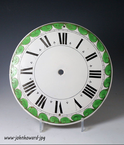 Antique English delftware clock dial with a green scrolled border late 18th century