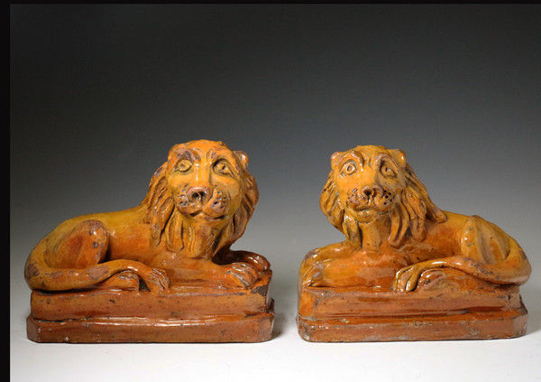 Pair of earthenware lions from Pill Pottery early 19th century period.