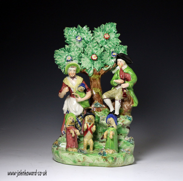 Antique Staffordshire pottery bocage figure group of Showmen. early 19th century.