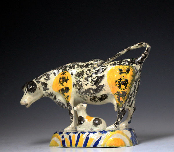 English pottery Pratt coloured cow creamer figure with calf, antique period 1810.