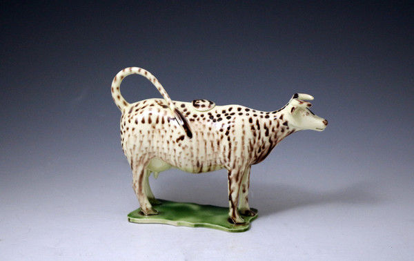  English pottery creamware bodied cow creamer figure decorated in oxide colours late 18th century antique period.