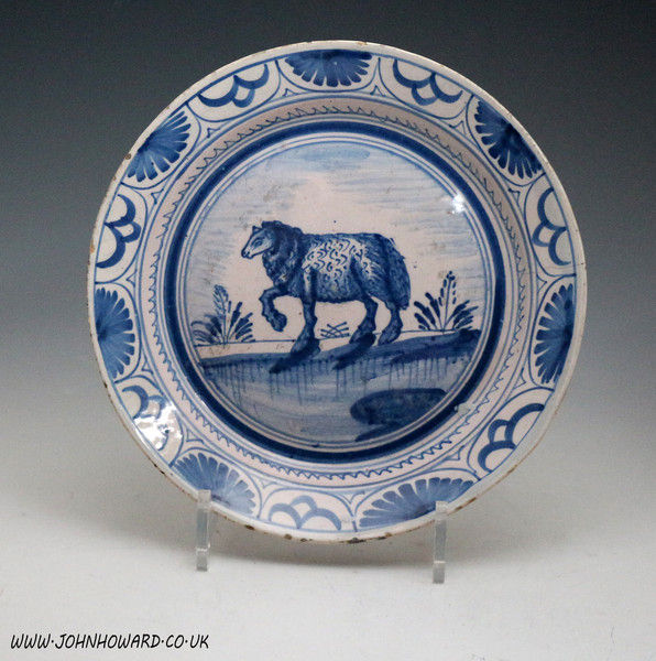 Blue and white delftware plate with image of a ewe in landscape c1725