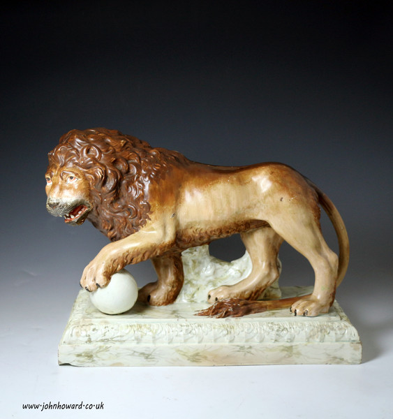 Antique Staffordshire pottery pearlware figure of a lion on base early 19th century period.