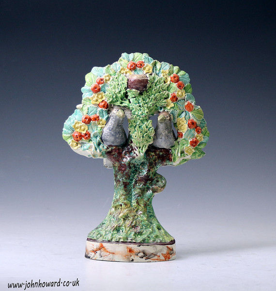 Staffordshire pottery bocage figure with two birds and nest in tree early 19th century English.