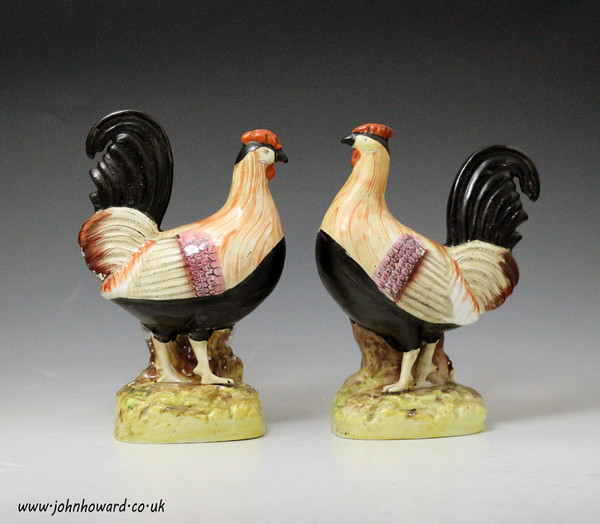 Antique Staffordshire pottery figures of roosters mid 19th century England.