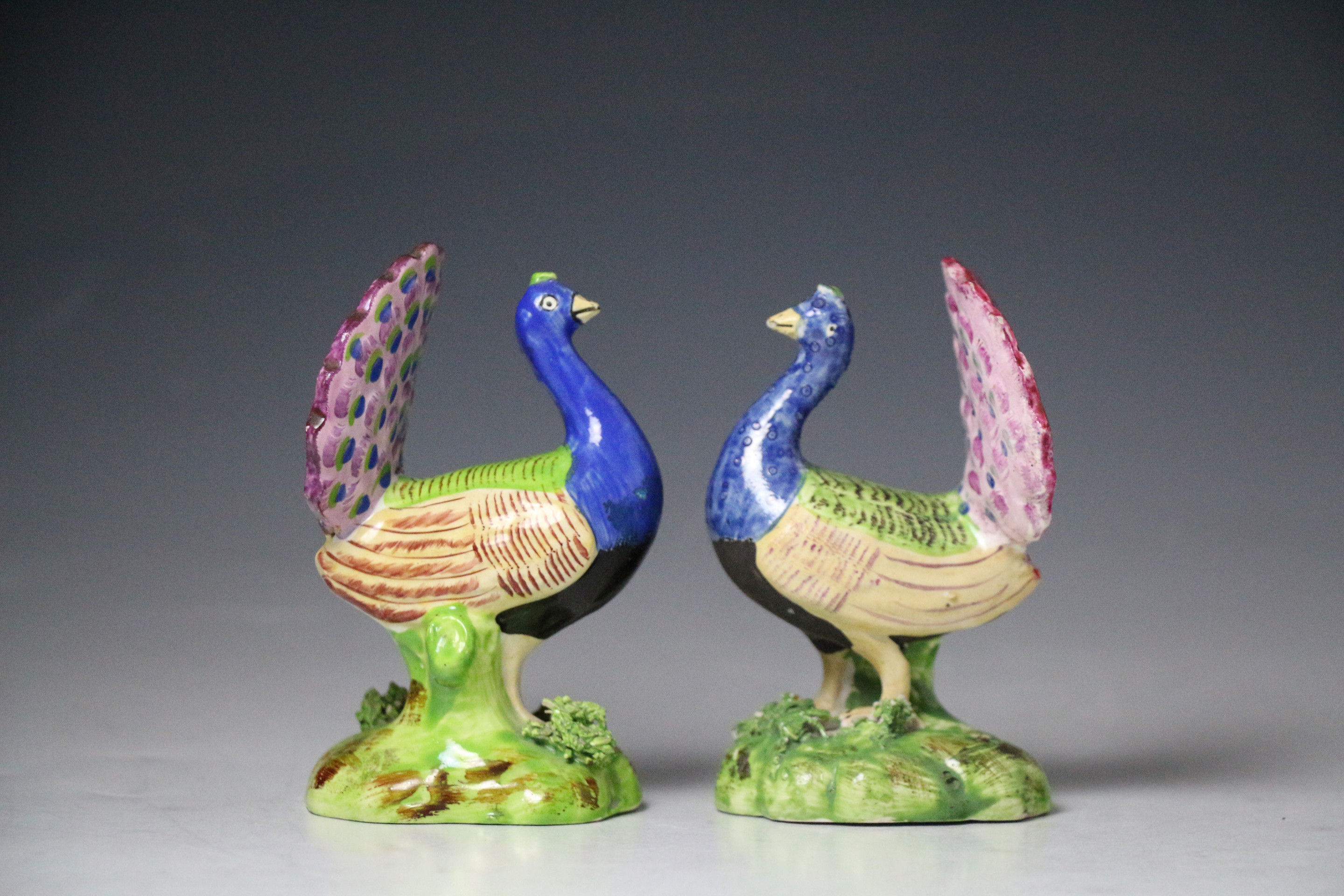 Two antique Staffordshire pearlware pottery figures of peacocks  early 19th century