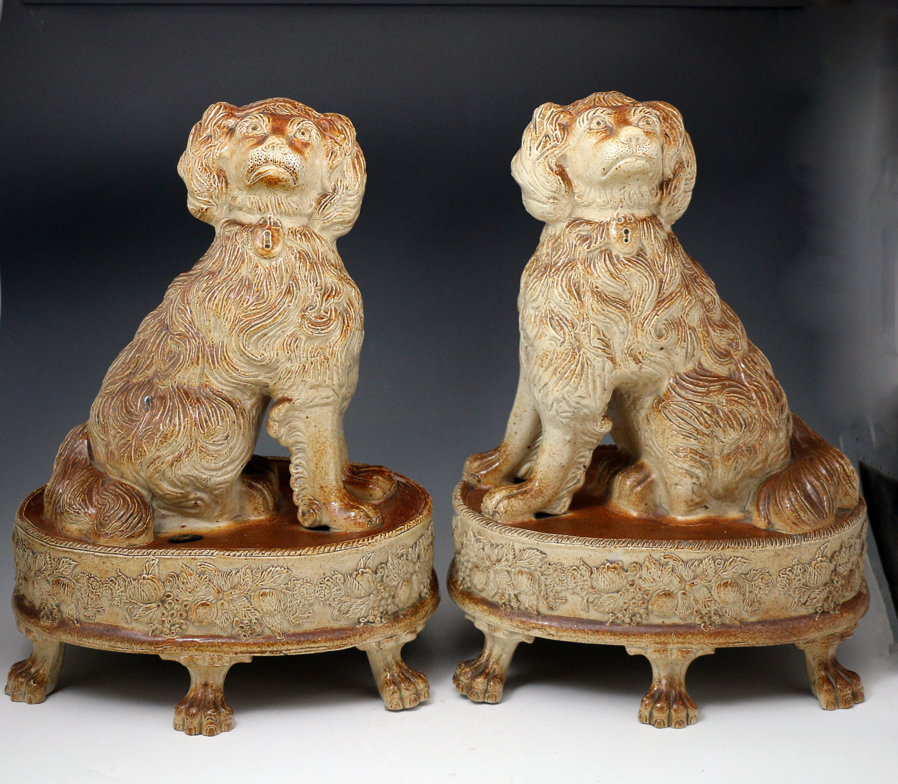 Pair of English saltglaze pottery figures of Spaniels on bases Briddon Derbyshire c1835