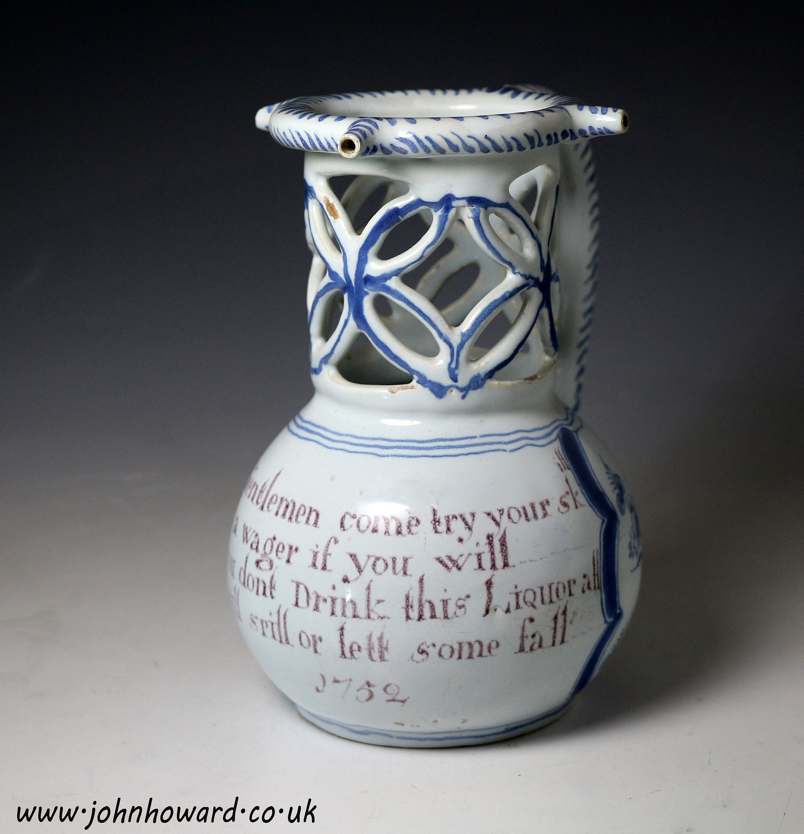 English dated  1752 delftware pottery puzzle jug in blue and manganese 