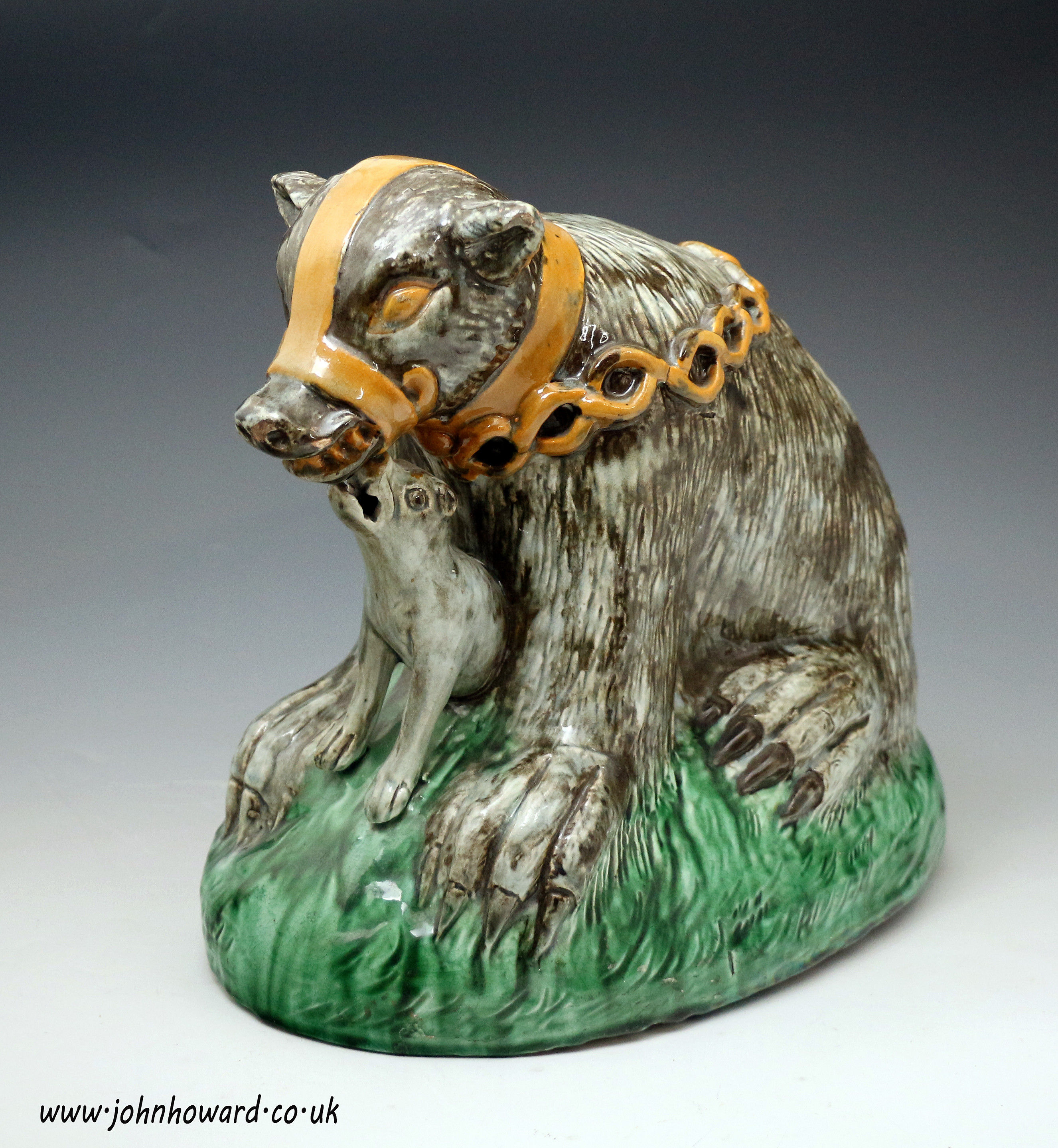 Large scale pottery figure of a muzzled  bear baited by a  ferocious  dog, late 18th century Staffordshire England