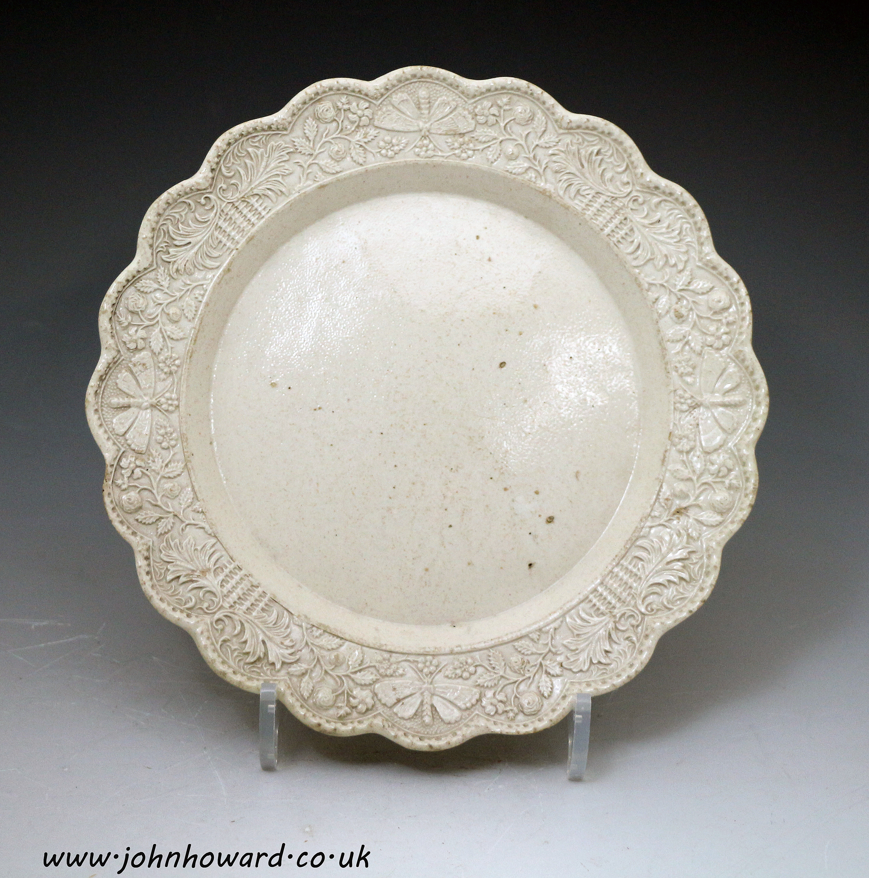 Stoneware saltglaze plate with relief decorated border , mid 18th century Staffordshire England