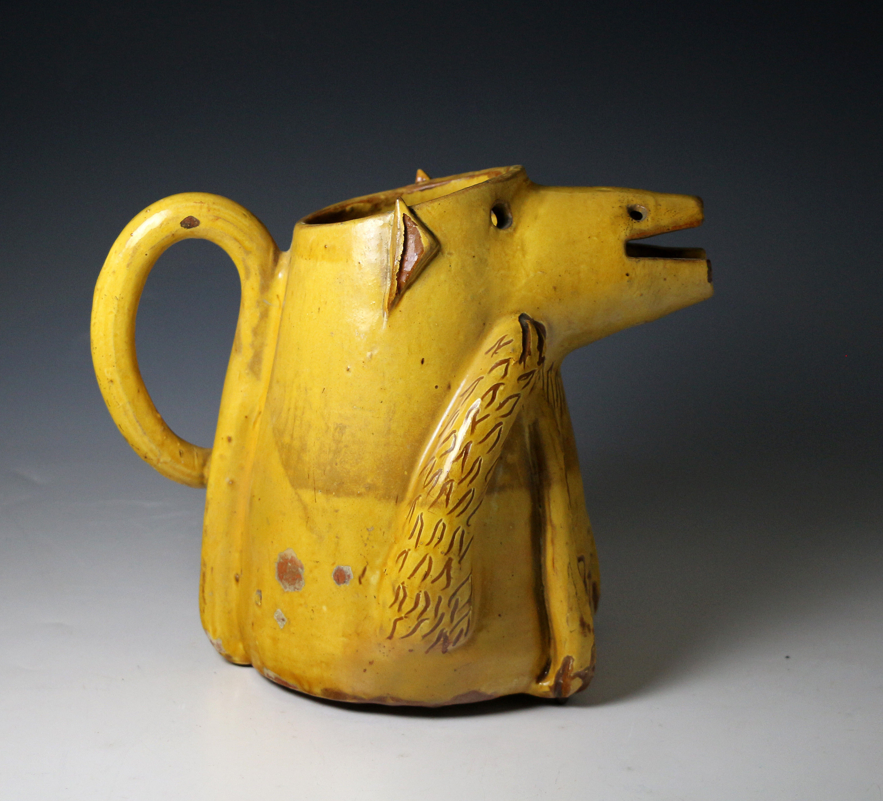 English pottery pitcher in the form of a bear and titled 