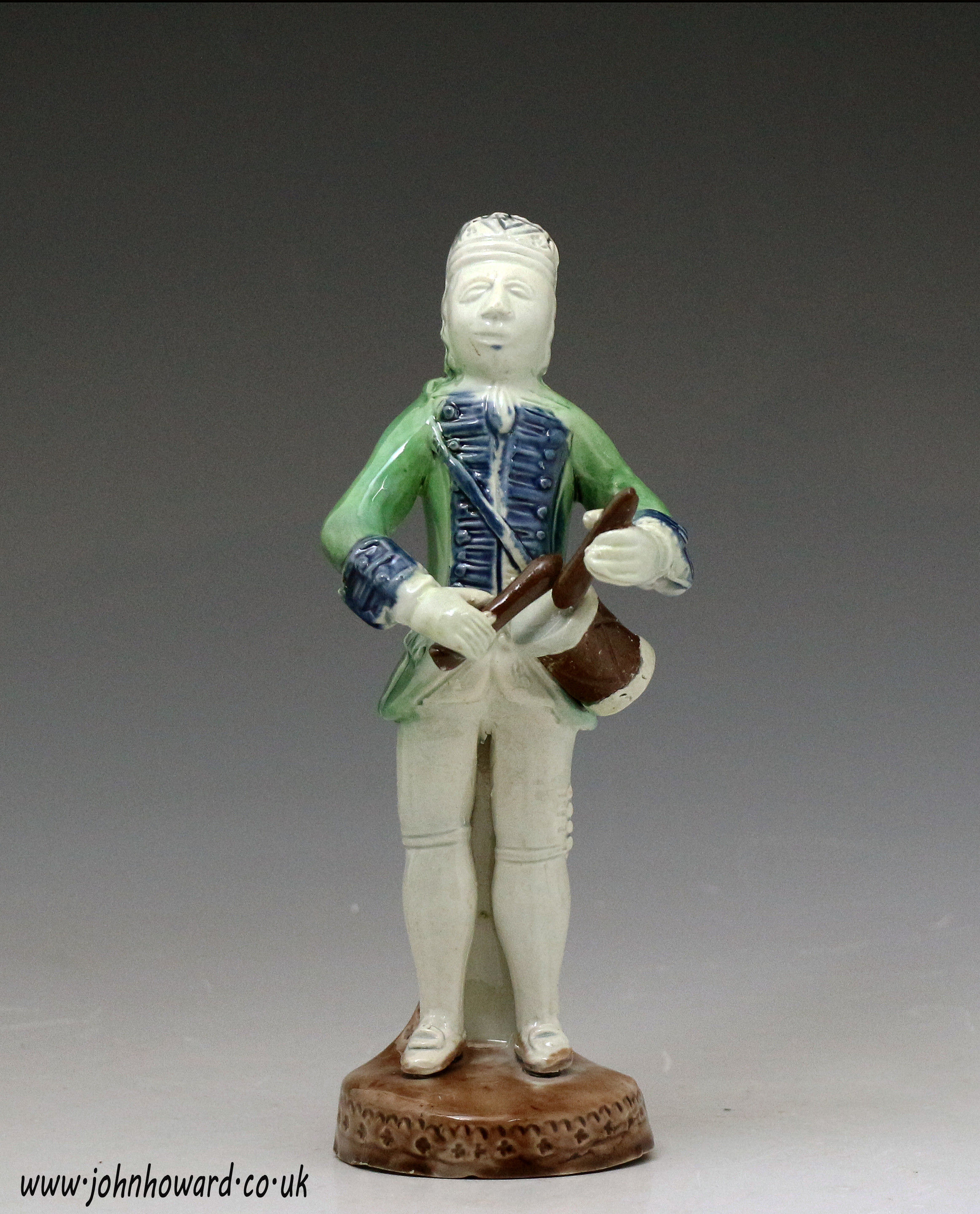 Antique mid 18th century figure of a drummer boy in the Whieldon fashion.