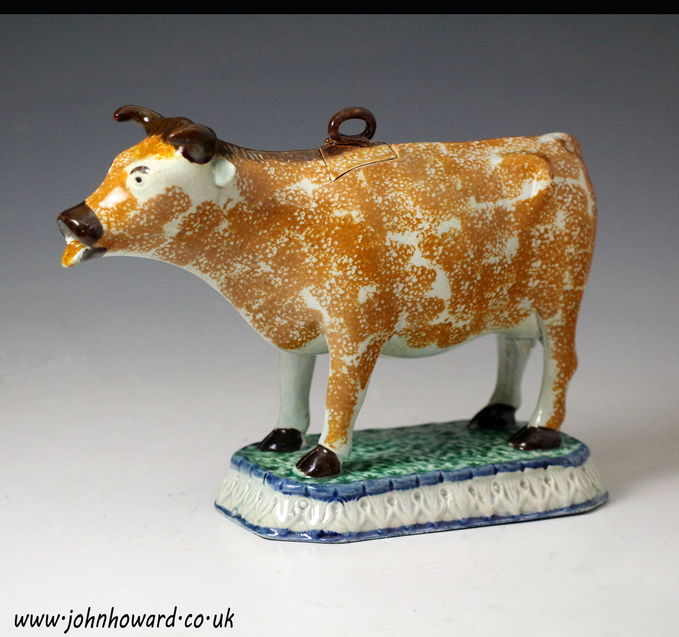 Antique English pottery figure of a cow creamer in Prattware circa 1800