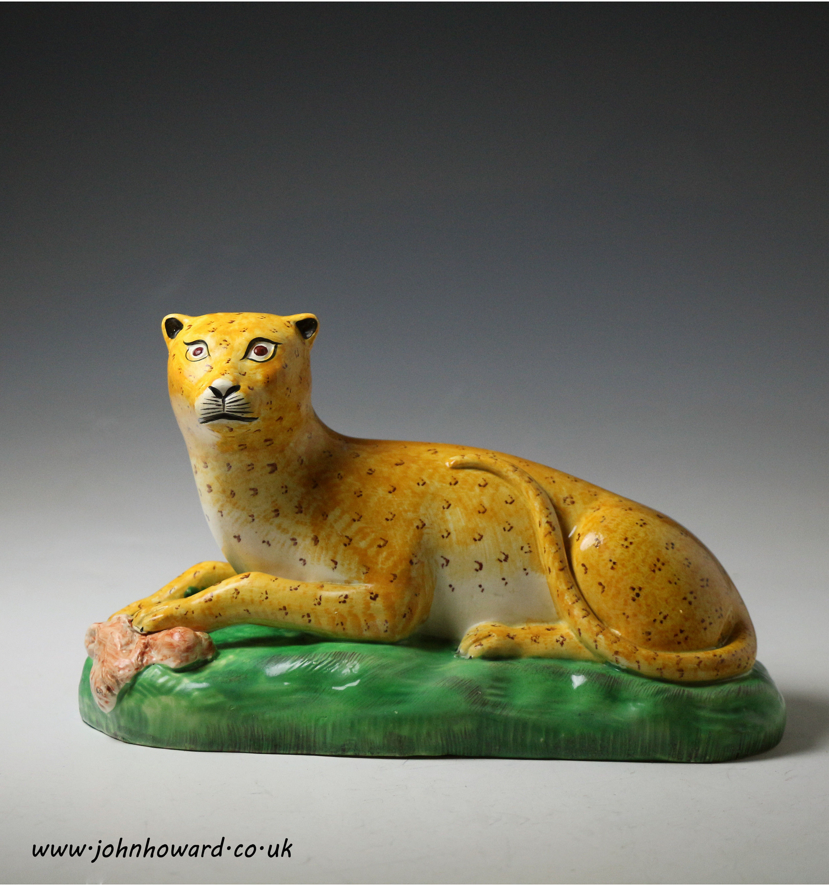 English pottery figure of a leopard on a green base creamware bodied early 19th century