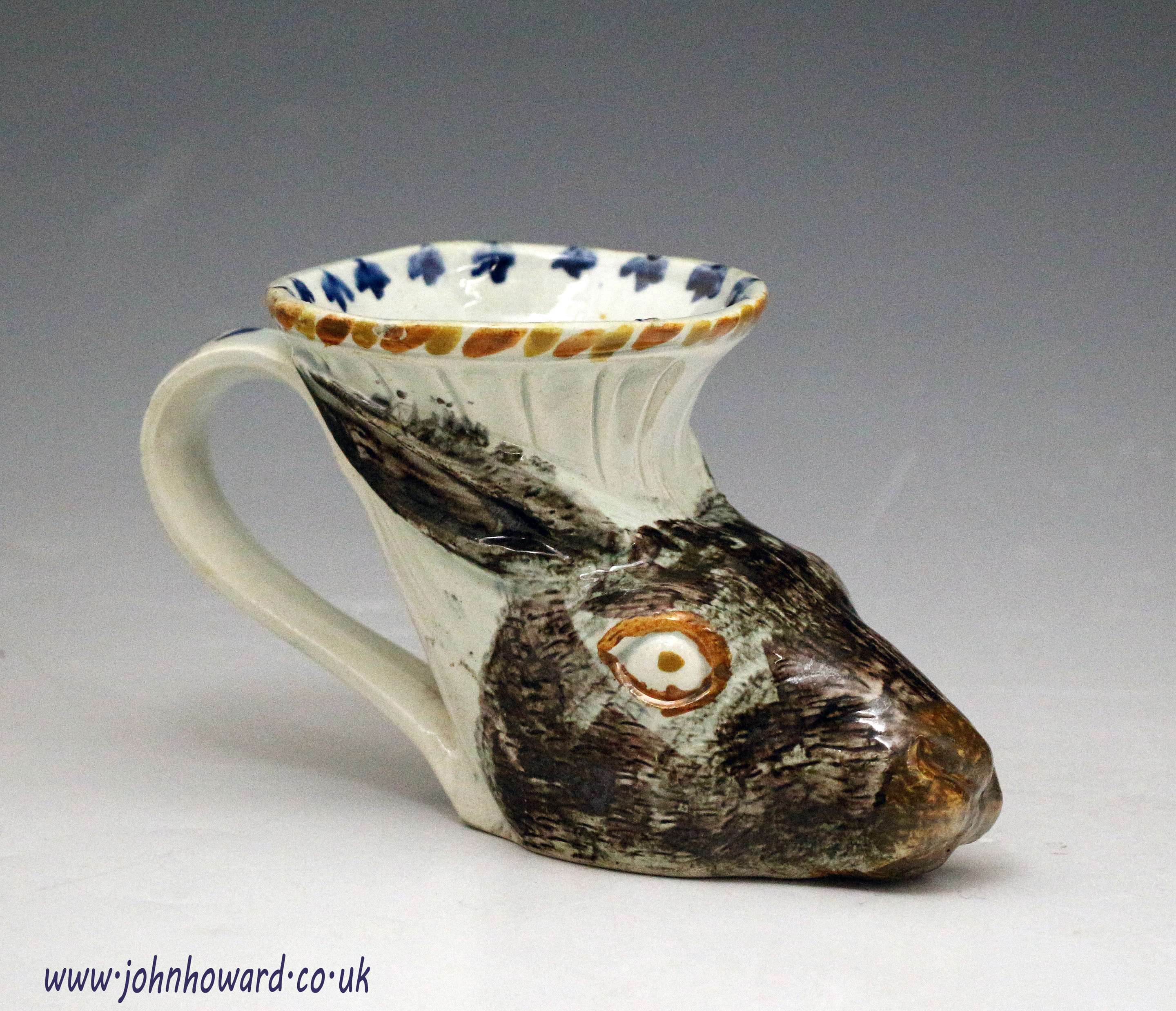 Antique English pottery prattware type stirrup cup in the form of a hare'e head c1810