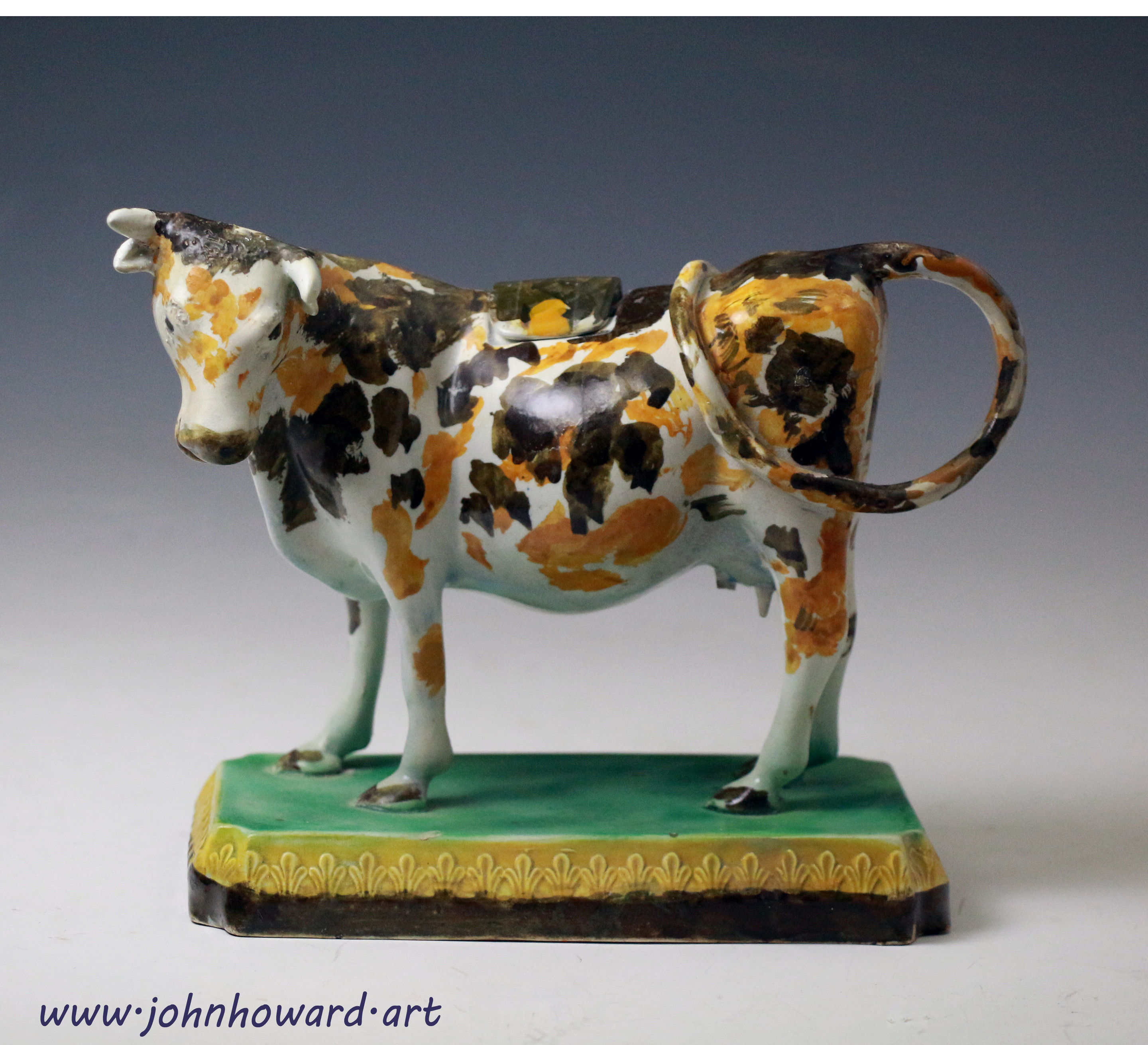 Antique English pottery figure of a cow creamer in Pratt colours circa 1800 period.