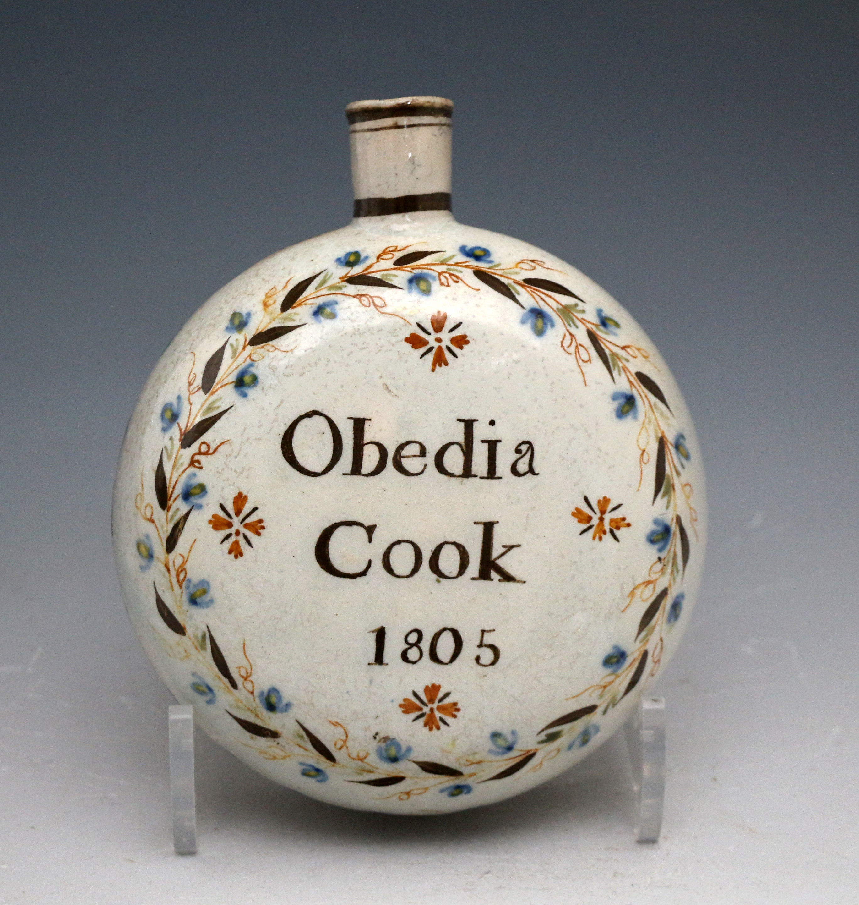 Antique English pottery spirit flask named and dated Obedia Cook 1805 in Pratt colours.