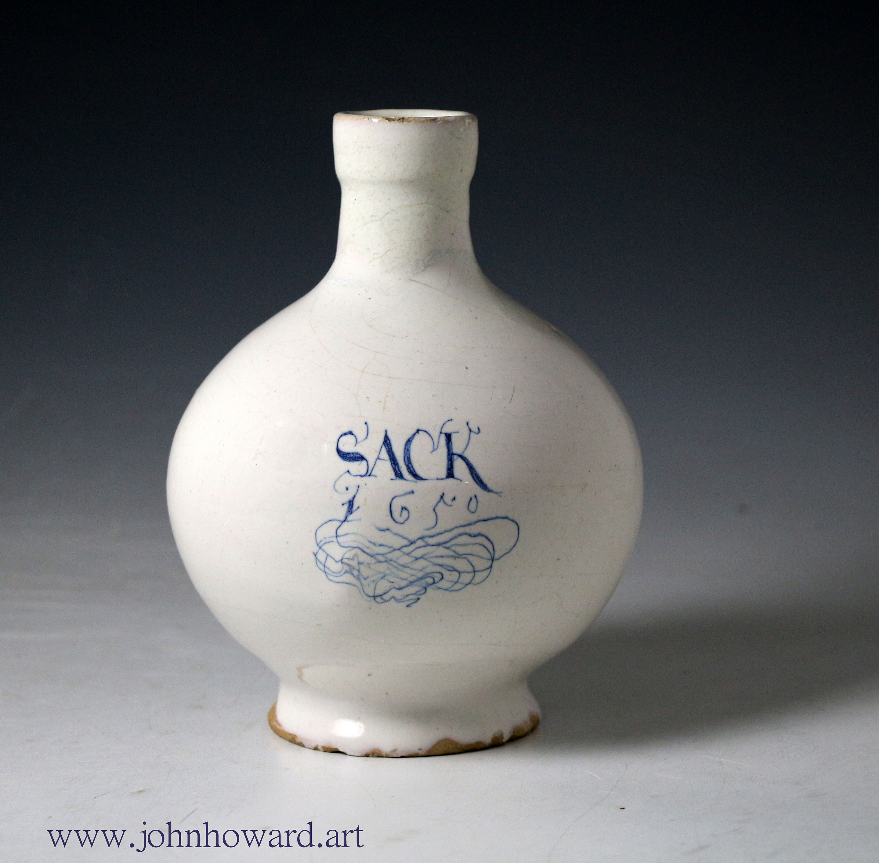 English delft wine bottle white glaze titled Sack and dated 1650 with an elaborate scroll