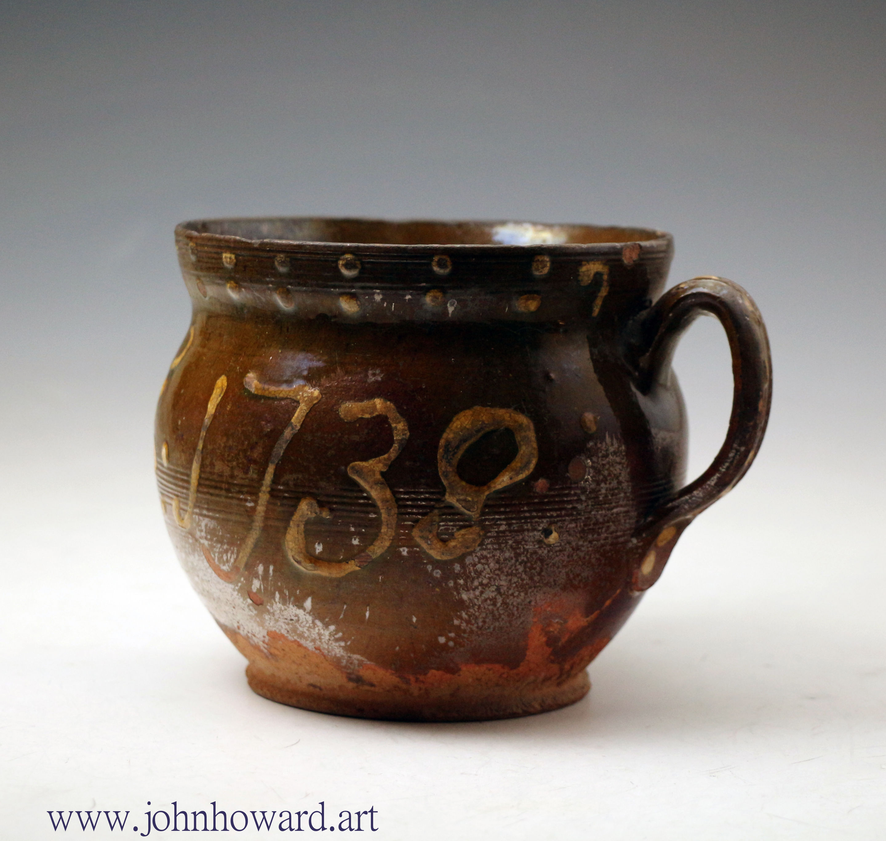 Slipware two handled mug dated 1738 and initialed WF, Wrotham pottery England