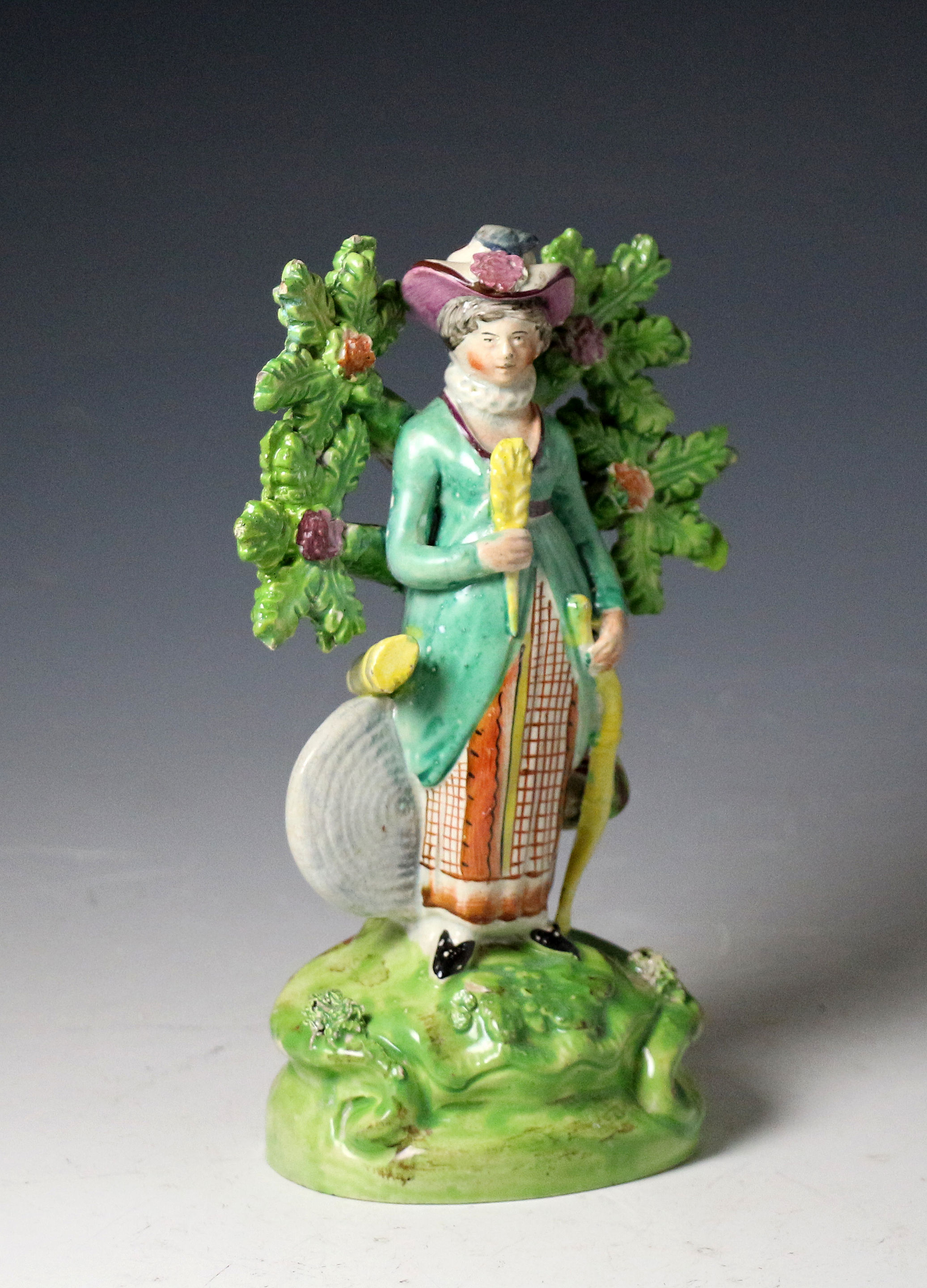 Antique Staffordshire pottery bocage figure of a female archer, pearlware made early 19th century English.