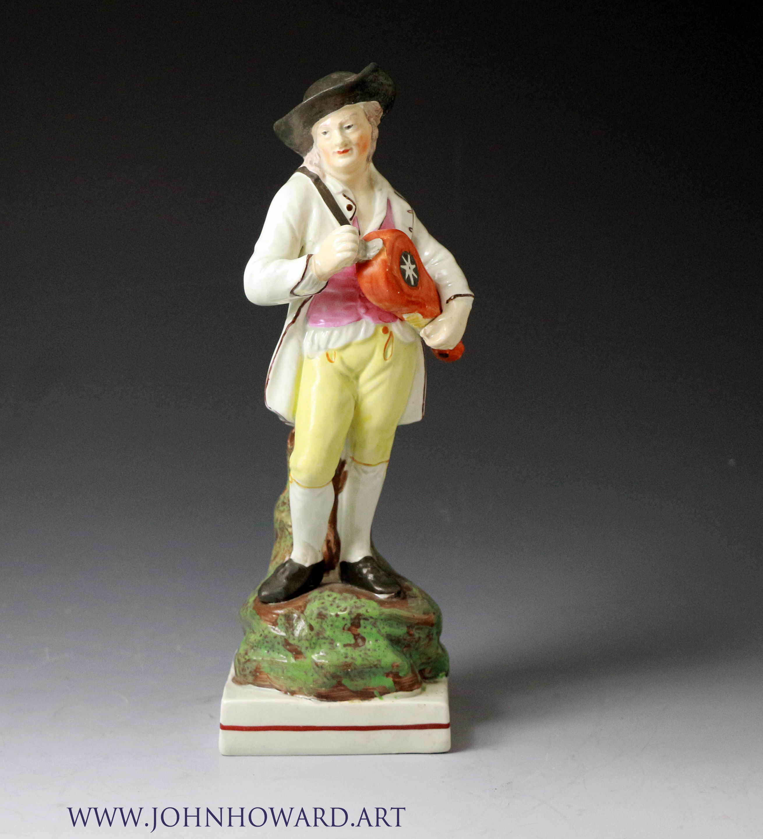 Staffordshire pottery figure of a Hurdy Gurdy player pearlware glaze ,antique period c1810