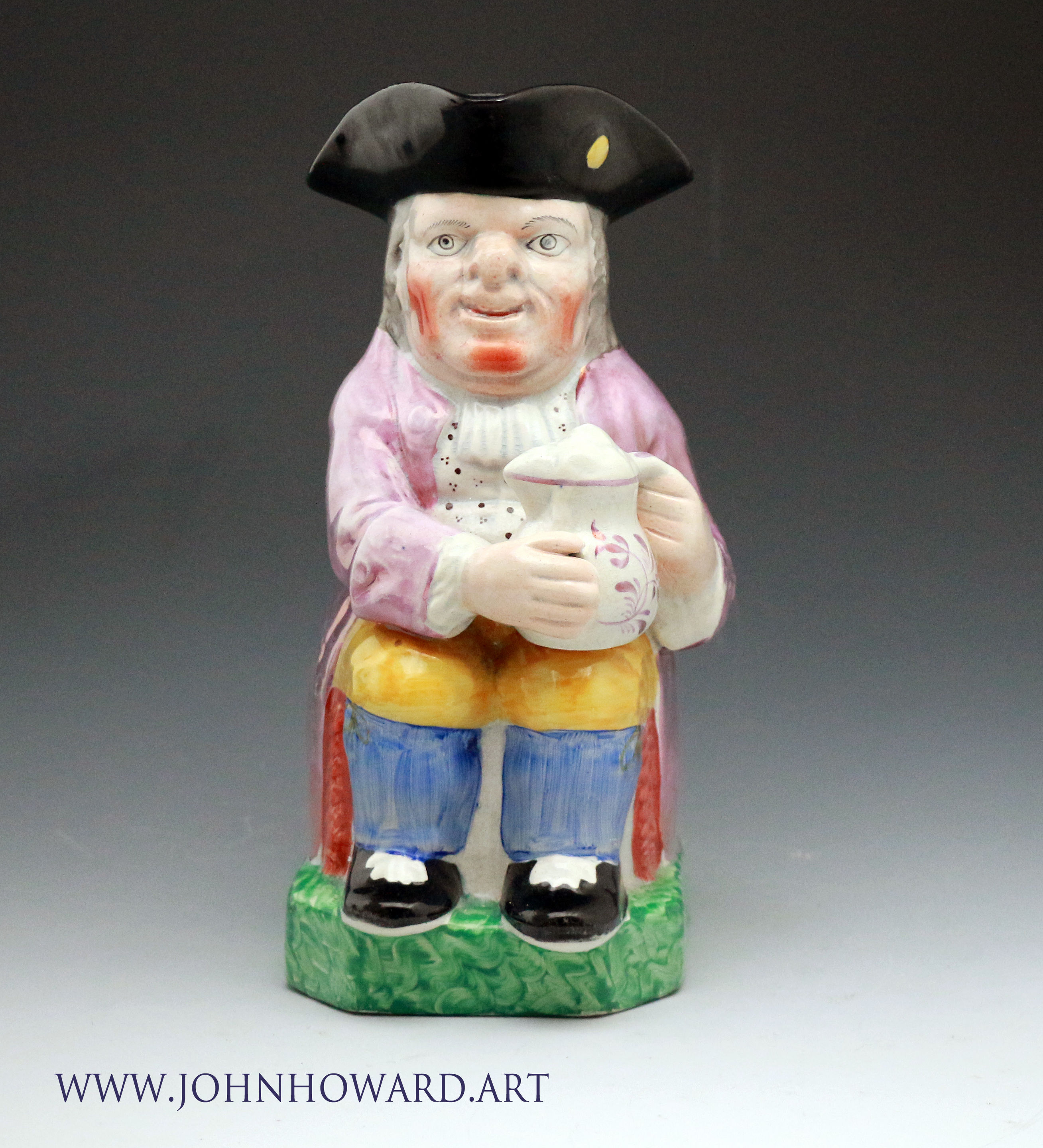 Antique Staffordshire pottery toby jug with pink luster early 19th century English.